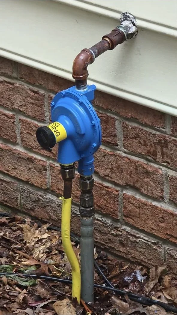 New propane regulator freshly installed on the exterior gas line of a Westminster, MD home