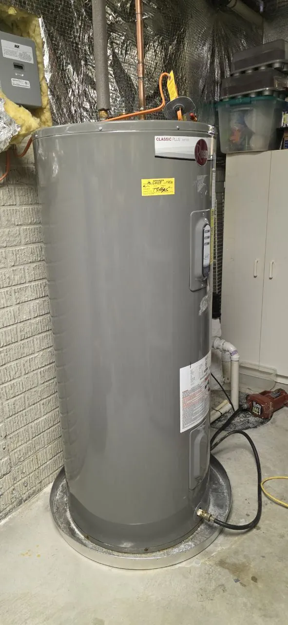 Close-up of rust and mineral deposits on leaking electric water heater